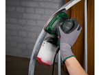 PARKSIDE® orbital sander sanding a metal bar, with a gloved hand holding the tool.