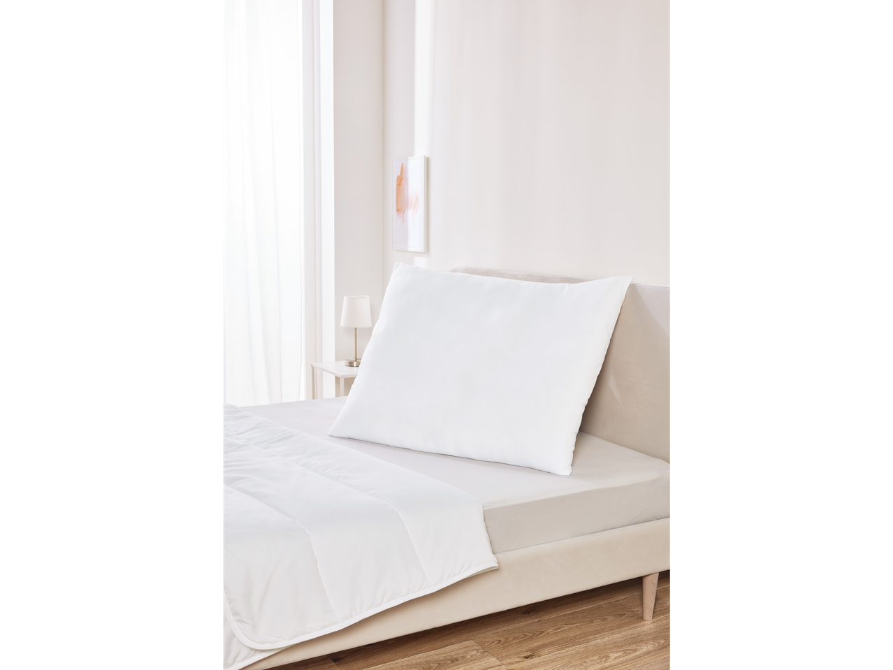 White pillow and duvet on a bed.