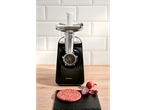 SILVERCREST® electric mincer with a raw burger patty and red onion on a wooden counter.