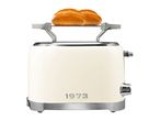 Retro-style cream toaster with a warming rack holding two bread rolls, featuring '1973' on the front.