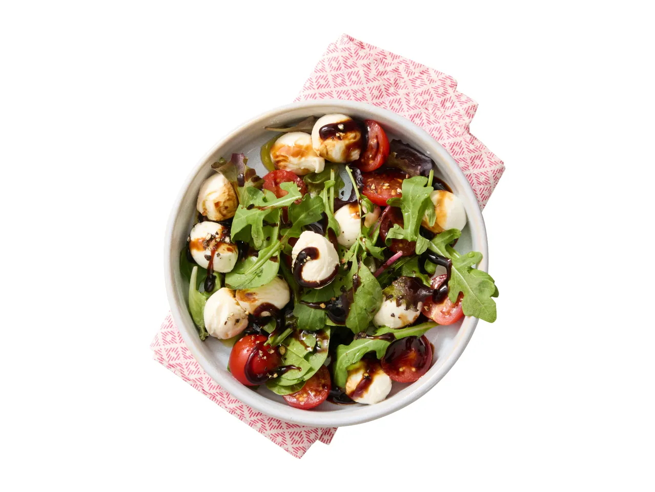 Caprese salad with mozzarella balls, cherry tomatoes, arugula, and balsamic glaze.