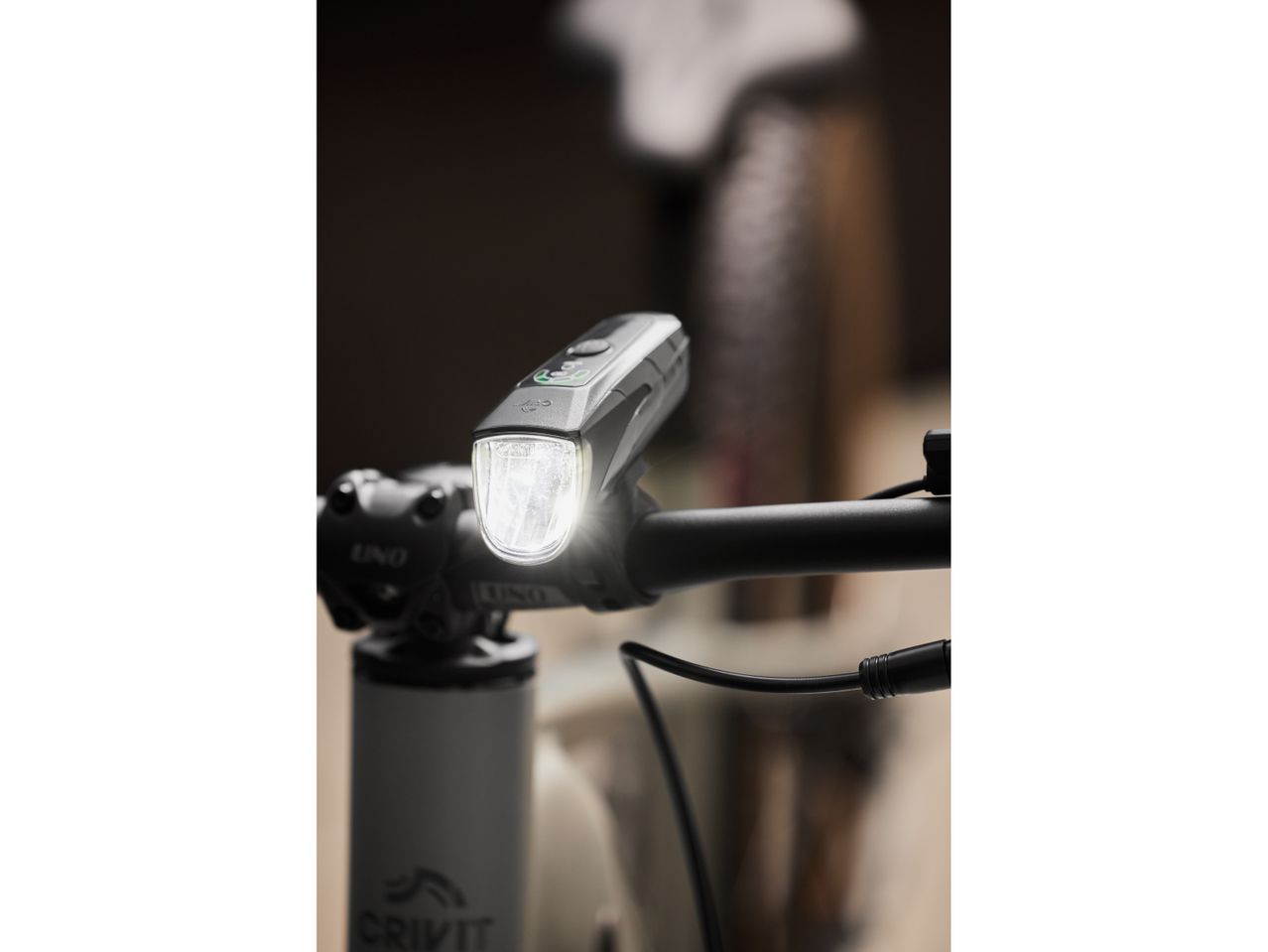 Crivit bike light attached to handlebars, illuminated.