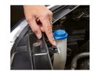 A hand pointing to a black plastic push pin fastener on a car's windshield washer fluid tank.