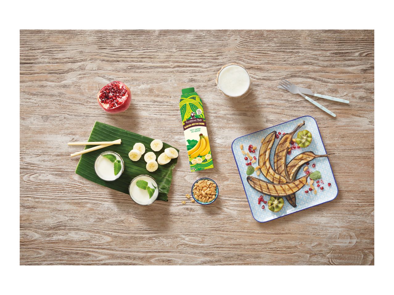 Caribbean-style banana nectar drink with grilled bananas, pomegranate, kiwi, and peanuts.