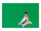 A smiling boy on a colorful wooden rocking toy against a green background.
