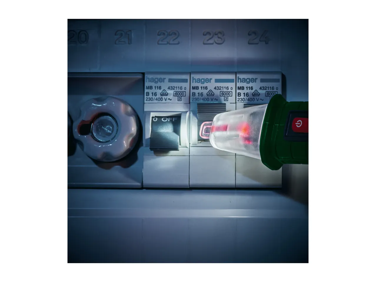 A voltage tester checking a circuit breaker in an electrical panel.