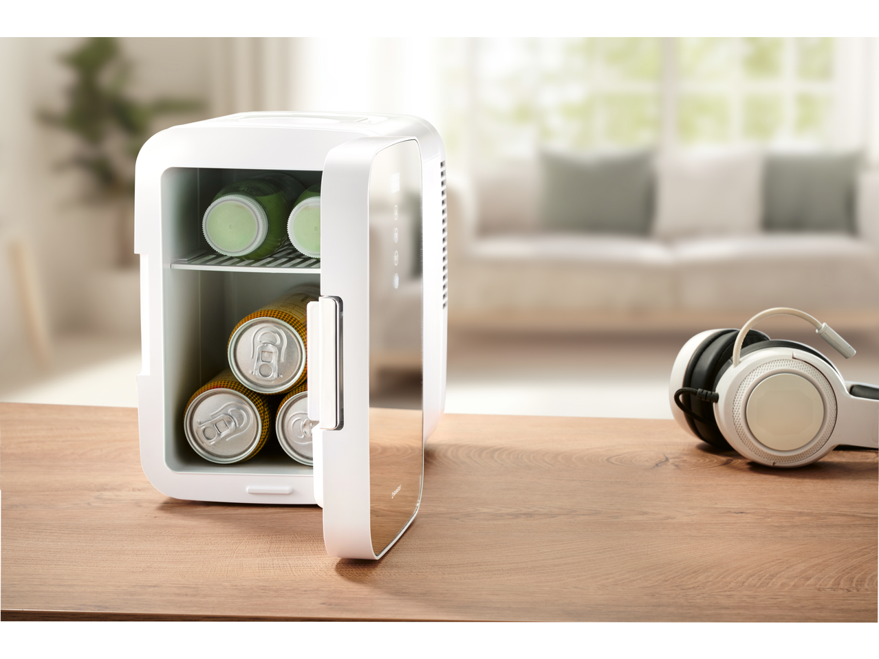 SILVERCREST® Mini Fridge with drinks and headphones on a wooden table