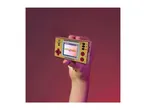 Hand holding a retro pocket game console with 'SEICROSS' on the screen.