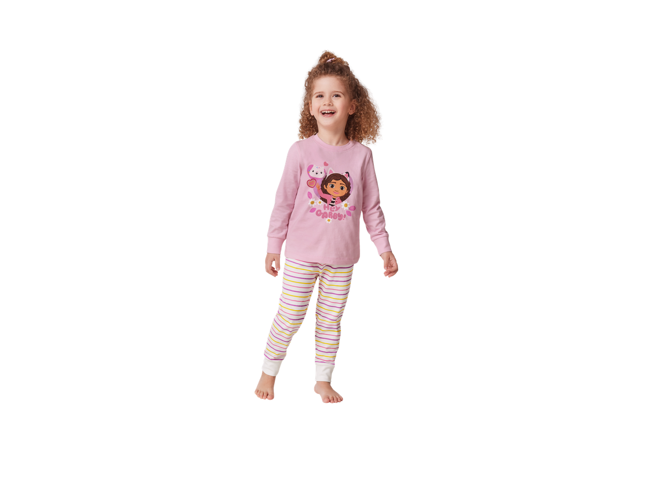 A young girl wearing pink Gabby's Dollhouse pyjamas with striped bottoms.