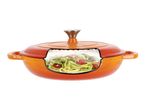 Orange cast iron Dutch oven with a cross-section showing zucchini noodles and cherry tomatoes.