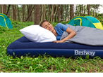 Person sleeping on a Bestway air mattress in a campsite.
