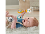 Happy baby playing with two Fisher-Price rattles on a fluffy rug.
