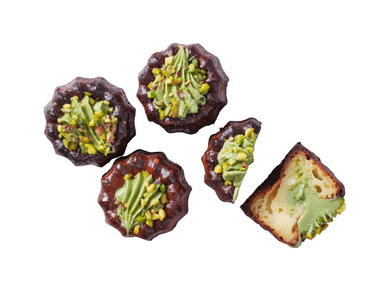 Cannelé koogikesed pistaatsiakreemi ja -puruga, üks neist pooleks lõigatud.