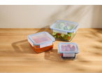 Three SILVERCREST® Glass Food Storage Containers with salad, sauce, and berries on a wooden table.