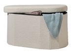 Cream-colored storage ottoman with a partially open lid, revealing a light blue knitted blanket.