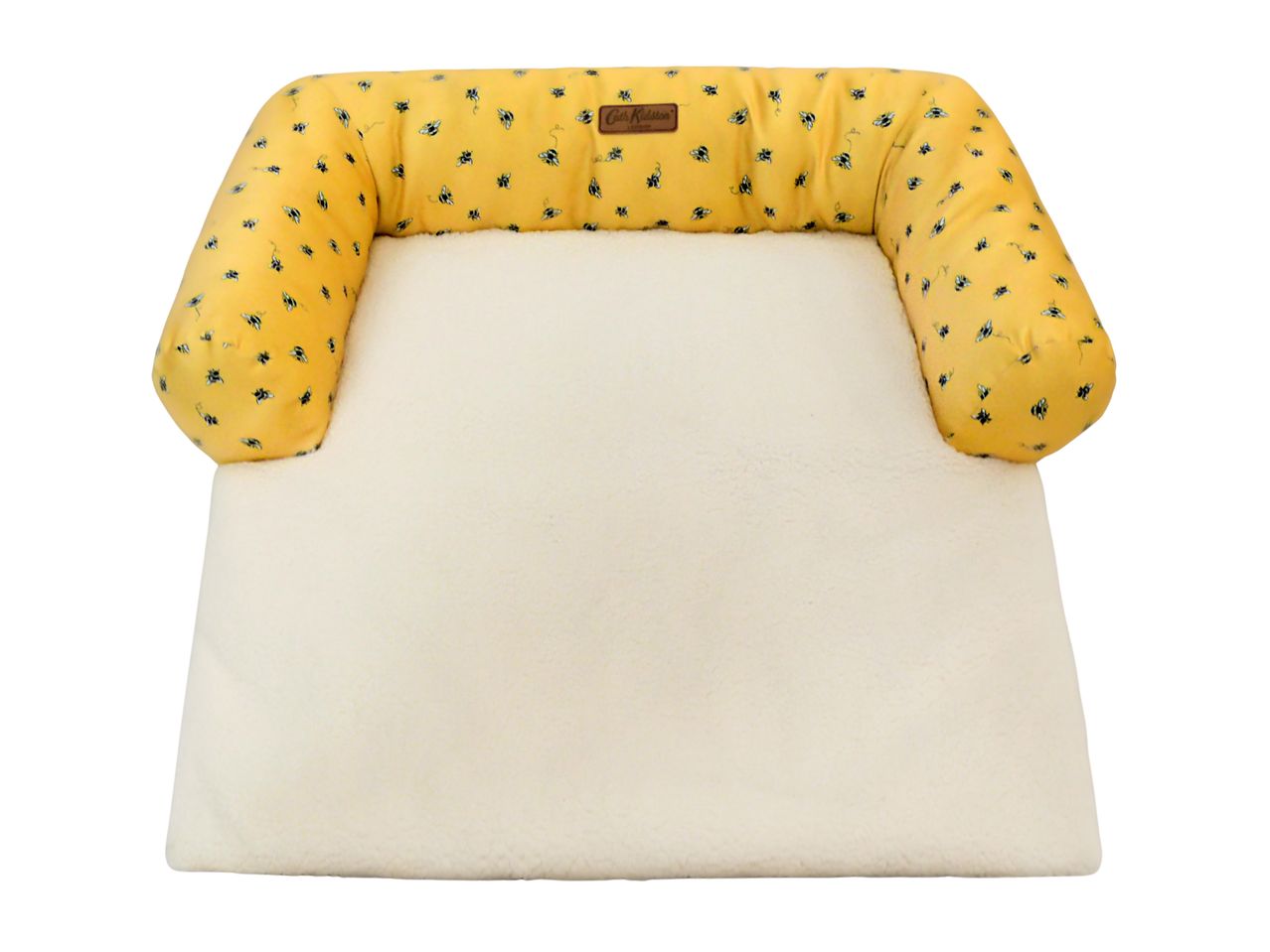 Yellow pet bed with a bee pattern and a cream fleece base, featuring a Cath Kidston label.