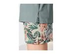 Light blue t-shirt with side slits over floral print shorts.
