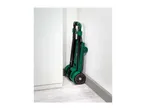 Folded green hand truck with black wheels and red accents, stored in a corner.