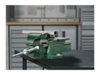 Green workbench vise clamping a metal square tube, on a black workbench in a workshop.