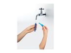 Hands filling a blue bubble wand with water from a tap, holding a blue cap in the other hand.