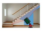 A laser level projecting lines on a staircase in a modern home.