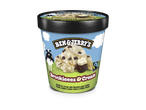 Een pint vanille-ijs met brownie-stijl koekjesdeeg, gouden koekjeswervelingen en witte stukjes.