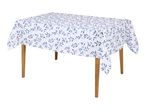 White tablecloth with a blue leaf pattern draped over a wooden table.