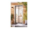 Magnetic fly screen door on a patio with wooden wall and outdoor seating.