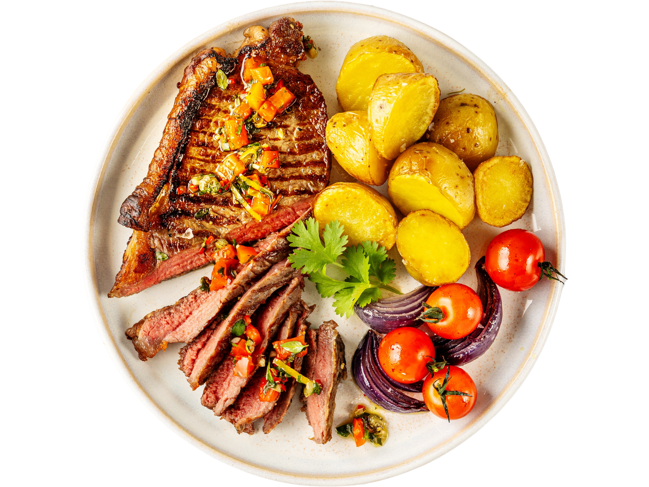 Grilled steak with salsa, roasted potatoes, cherry tomatoes, and red onion on a plate.