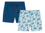 Dvoje dječjih kratkih hlača: jedne plave i jedne svijetloplave s uzorkom palmi.