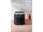 A black SILVERCREST® XL Air Fryer on a wooden counter with fries and sauce.