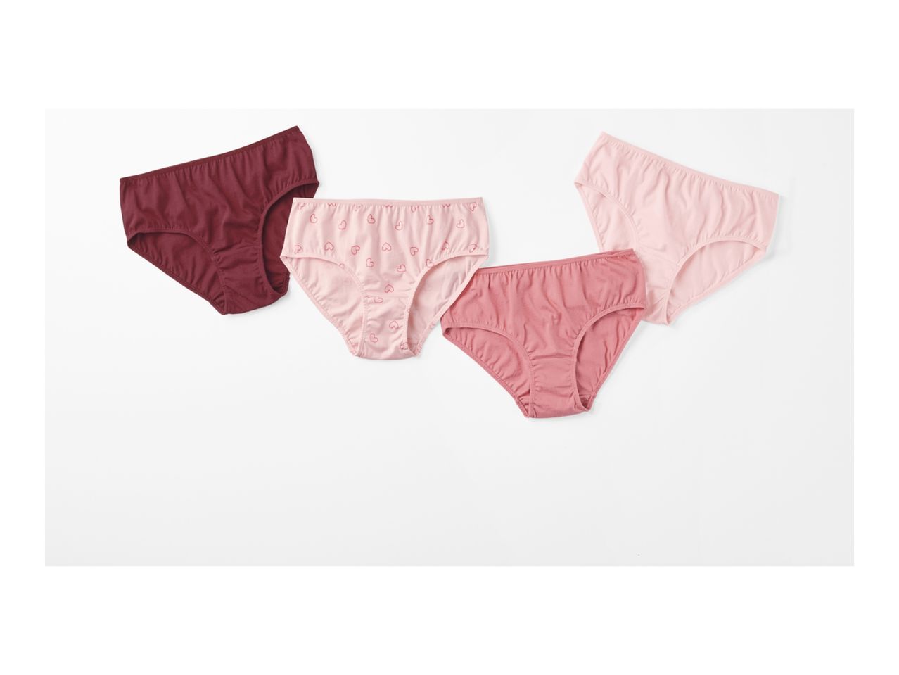 Three pairs of women's cotton panties in burgundy, pink with hearts, and rose.