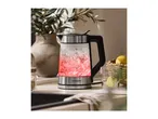 SilverCrest glass kettle with red illuminated boiling water, next to a glass with lemon.