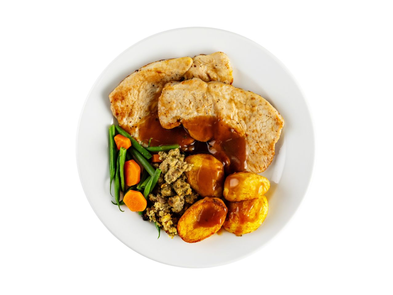 A plate of roast beef with gravy, roast potatoes, and vegetables.