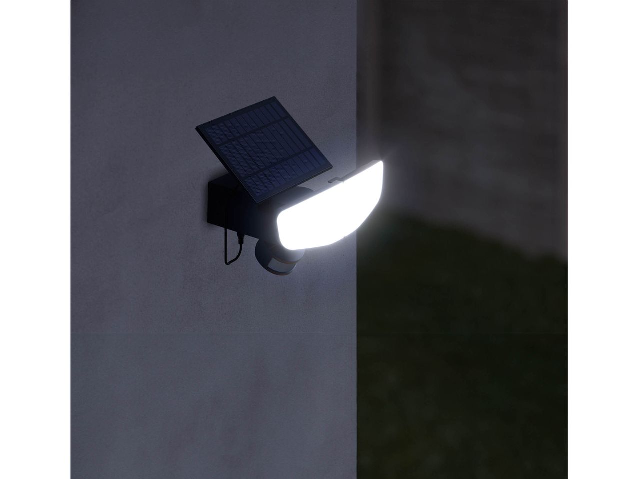 A solar-powered outdoor light illuminating a dark area.