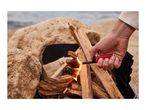 A hand lighting a campfire with a red long-reach lighter, surrounded by rocks and water.