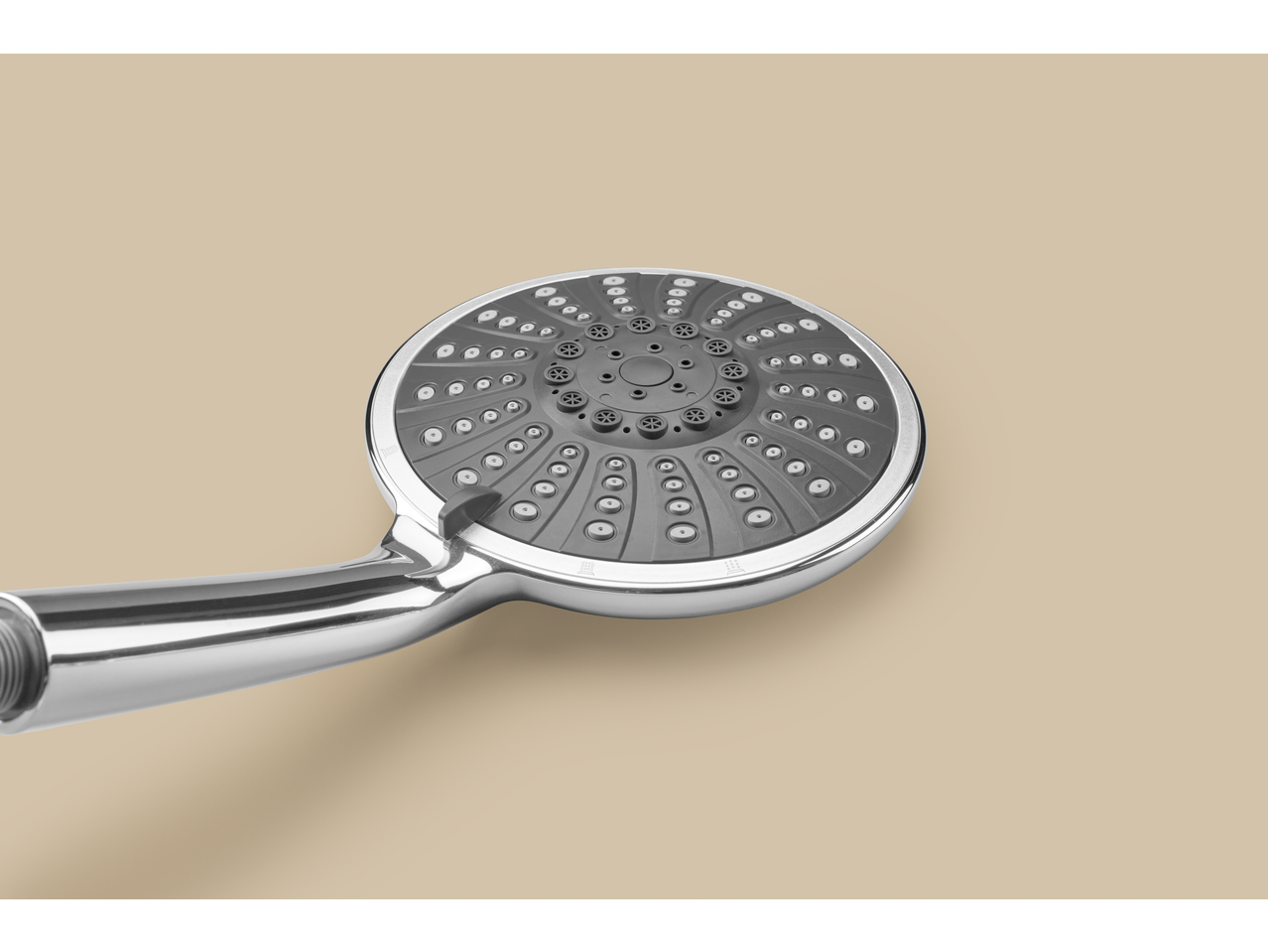 Close-up of a modern chrome shower head with a gray spray face and multiple settings.