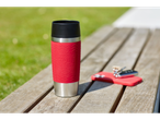 Red Tefal travel mug on a wooden bench with keys and a phone