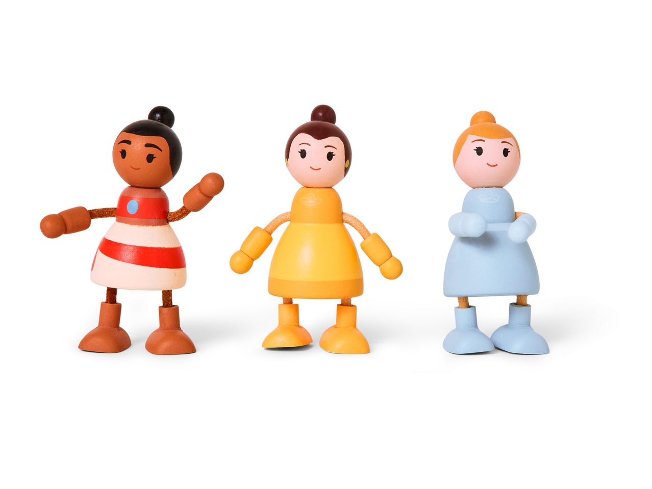 Three wooden doll figures, one in red and white, one in yellow, and one in light blue.