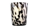 Scented candle in a decorative black and white spotted glass jar