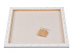Back of a blank stretched canvas with wooden stretcher bars and a bag of wooden wedges.