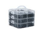 A clear plastic storage container filled with black push pins.