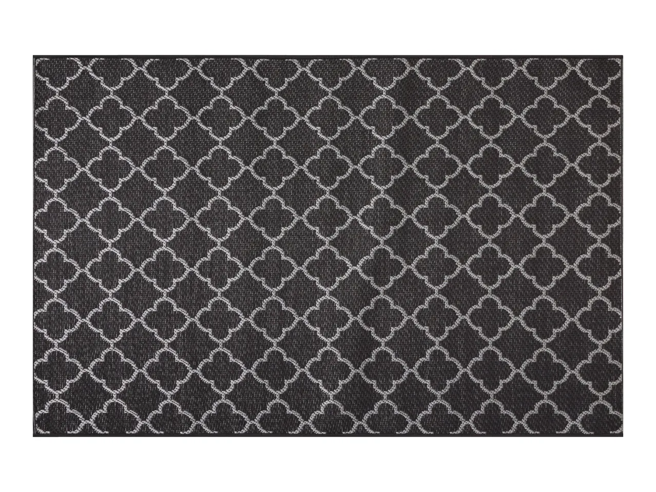Black and white geometric patterned rug with a quatrefoil design.
