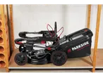 Parkside Performance® petrol lawnmower, black with red accents, on a wooden shelf