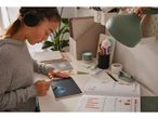 Girl using a LCD Writing Tablet and wearing headphones.