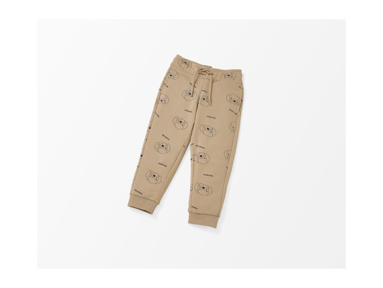 A pair of beige sweatpants with a pattern of dog faces and the word 'ADVENTURE'.