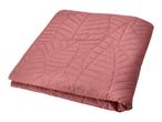 Folded pink quilted blanket with a leaf pattern