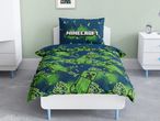 Minecraft-themed duvet cover and pillowcase set on a white bed in a child's room.