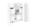 White pet safety gate with a small dog sitting behind it in a doorway.