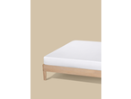 White mattress on a light wooden bed frame against a beige background.
